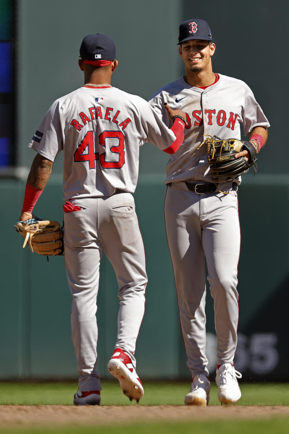 Boston Red Sox shortstop Ceddanne Rafaela (43) and second baseman Vaughn Grissom, right, celebrate their win over the Minnesota Twins in a baseball game Sunday, May 5, 2024, in Minneapolis. (AP Photo/Bruce Kluckhohn)