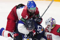 Czech Republic's Radko Gudas, center top, checks Finland's Arttu Hyry, center, as Czech Republic's goalkeeper Lukas Dostal makes a save during the preliminary round match between Czech Republic and Finland at the Ice Hockey World Championships in Prague, Czech Republic, Friday, May 10, 2024. (AP Photo/Petr David Josek)