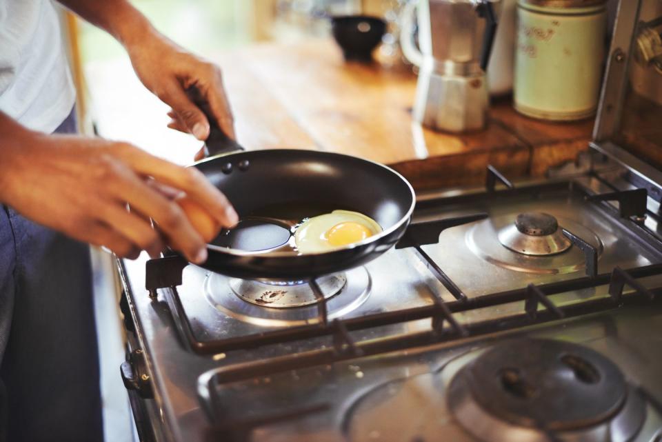 cropped shot of a man making fried eggs for breakfasthttp19515417881dataicollagepushoots806370jpg