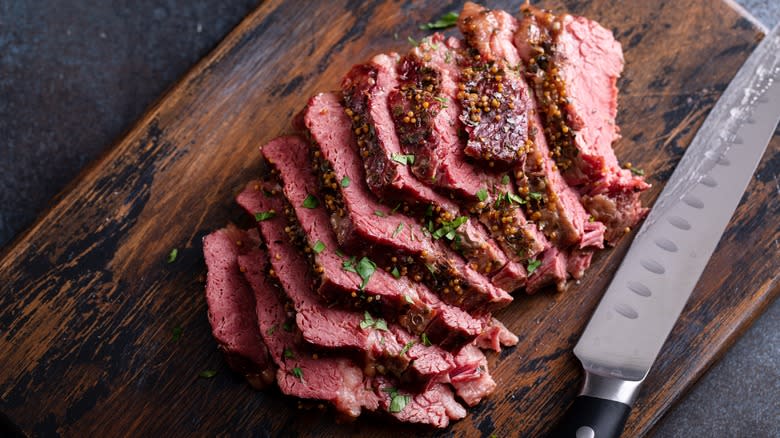 Sliced corned beef on cutting board