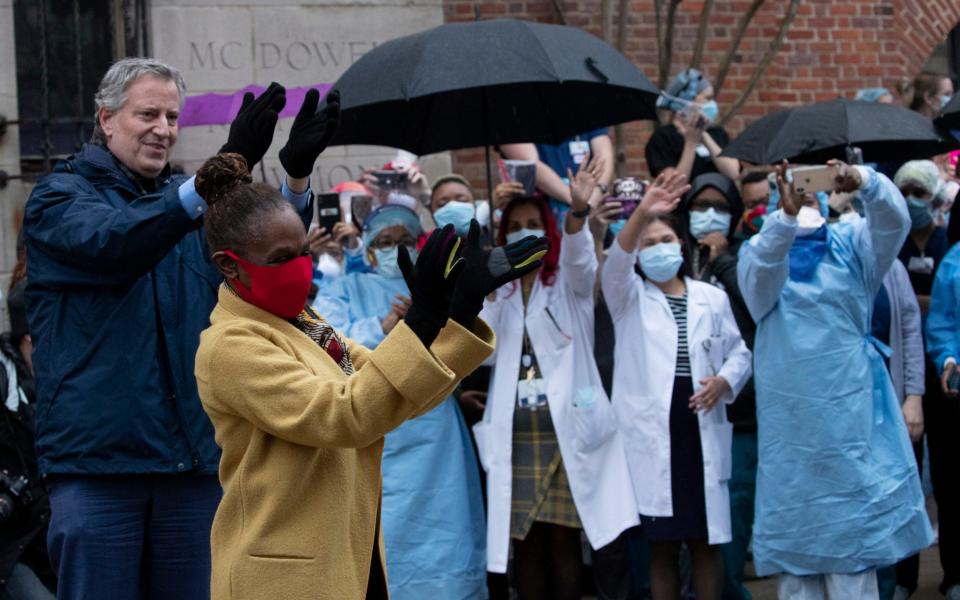 Mayor Bill de Blasio and his wife Chirlane McCray applaud healthcare workers at Brooklyn's Kings County Hospital Center  - AP