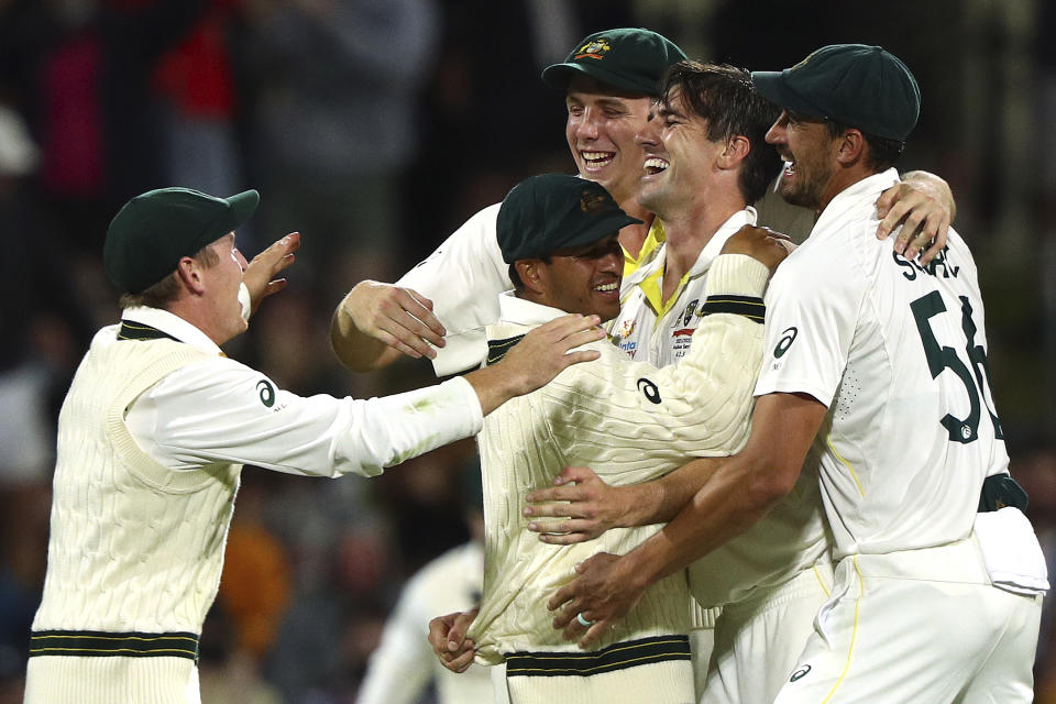 Australia's Pat Cummins, second right, celebrates with teammates after taking England's last wicket of the match and series during their Ashes cricket test match in Hobart, Australia, Sunday, Jan. 16, 2022. (AP Photo/Tertius Pickard)