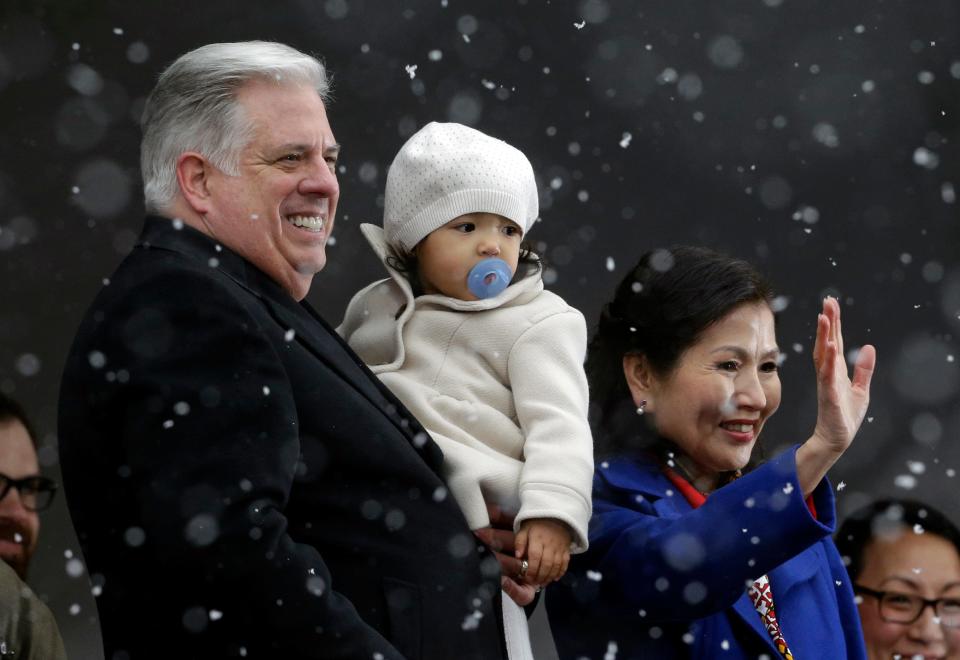 Maryland Gov. Larry Hogan holds his granddaughter Daniella Velez, then age 2, as he and his wife, Yumi, acknowledge supporters after inaugural ceremonies at the Statehouse in Annapolis in 2015.