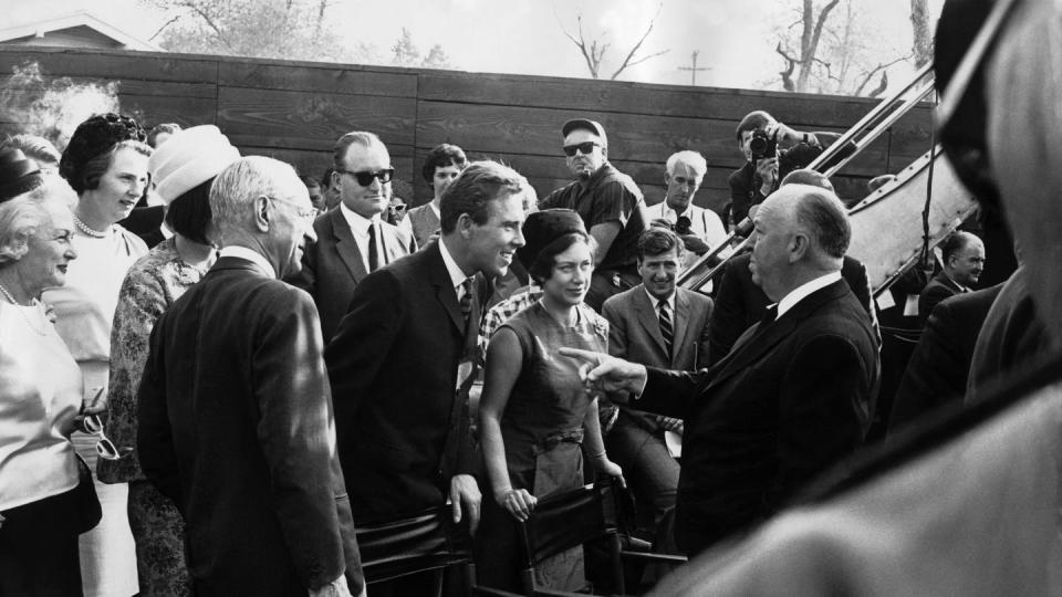princess margaret and lord snowdon talking with alfred hitchcock in hollywood in 1965