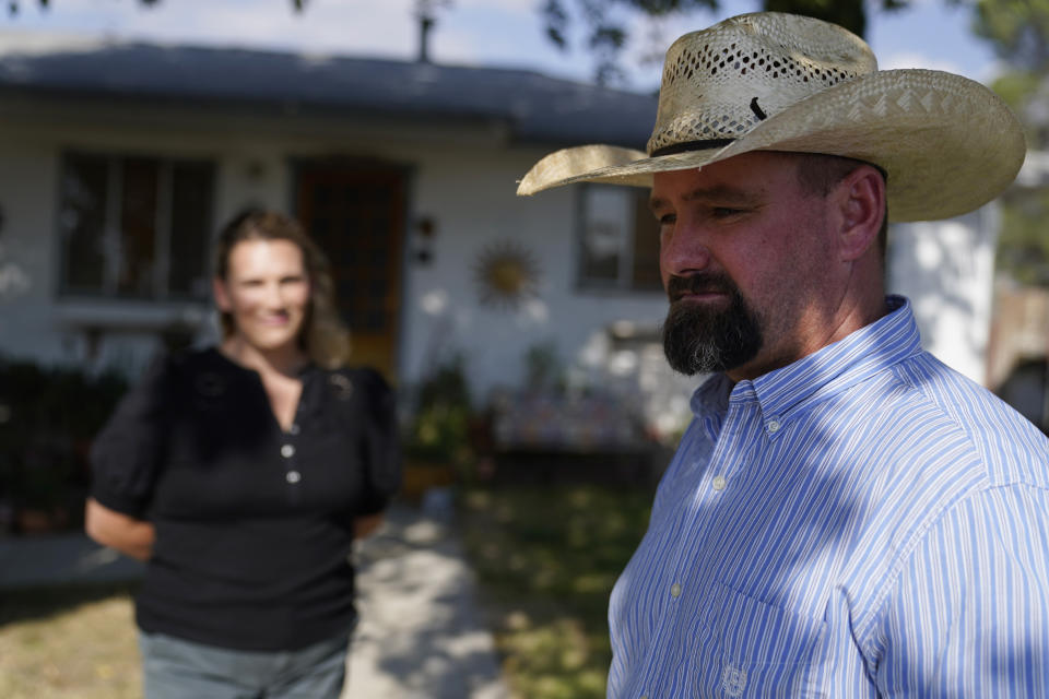 Jake Furstenfeld, a cattle rancher, stands with Ella Boyajian outside a house, Wednesday, Sept. 20, 2023, in New Cuyama, Calif. Furstenfeld and Boyajian are among the leaders of the carrot boycott being encouraged in the Cuyama Valley as a result of a water rights dispute with carrot producers Grimmway and Bolthouse. (AP Photo/Marcio Jose Sanchez)