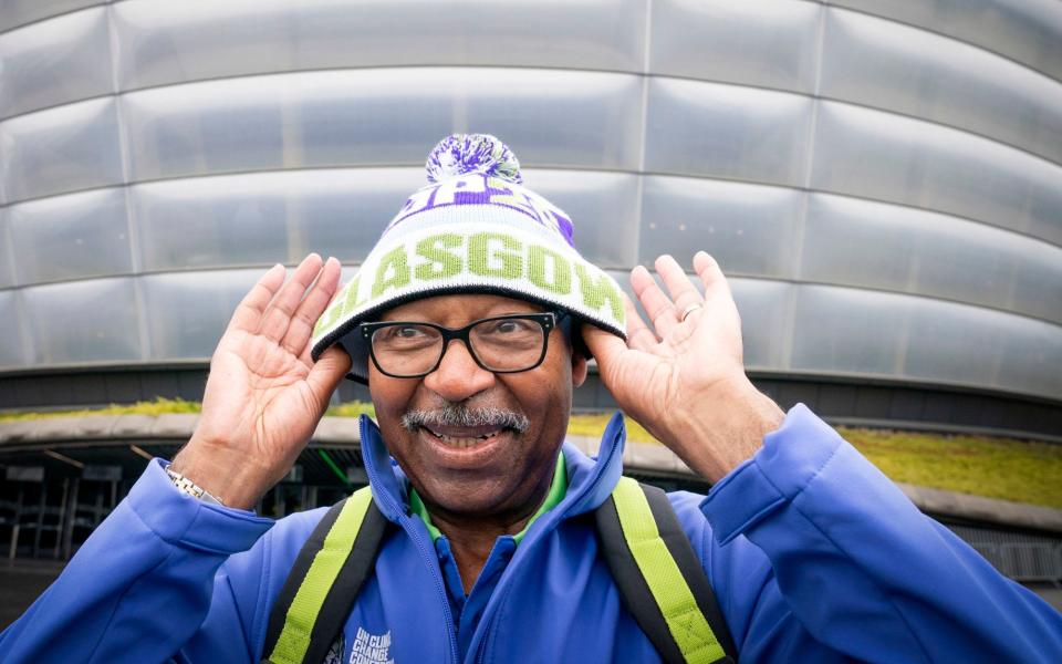 Volunteer Bob Alston models the official uniform that will be worn by around 1,000 volunteers at Cop26 - PA