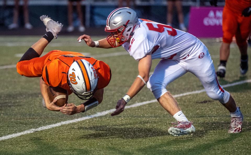 Washington's Thomas Borge, left, dives for extra yardage as Morton's Noah Losey moves in for the tackle in the first half Friday, Sept. 24, 2021 at Babcook Field. The Panthers defeated the Potters 35-14.