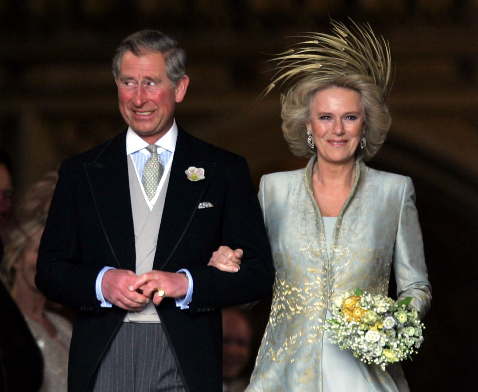 Britain's Prince Charles grins next to the Duchess of Cornwall as they leave St. George's Chapel in Windsor Castle, southern England, after the Service of Prayer and Dedication following their marriage, April 9, 2005. Prince Charles and his long-term partner Camilla Parker Bowles, who became Her Royal Highness the Duchess of Cornwall on their marriage, married on Saturday in a low-key ceremony. Pictures of the Month April 2005 REUTERS/Toby Melville PICTURES OF THE YEAR 2005  TM/CRB/SM