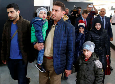 Unidentified people from Douma, Syria, arrive at a news conference in the Hague, Netherlands, April 26, 2018. REUTERS/Michael Kooren