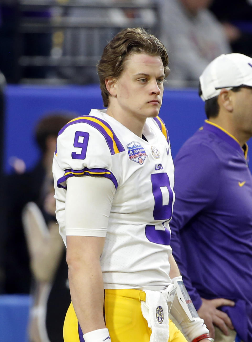 FILE - In this Jan. 1, 2019, file photo, LSU quarterback Joe Burrow attends warmups before the Fiesta Bowl NCAA college football game against UCF in Glendale, Ariz. This year, a group of talented and experienced quarterbacks could help the Southeastern Conference produce a little more drama. Georgia’s Jake Fromm, LSU’s Burrow, Florida’s Feleipe Franks and Texas A&M’s Kellen Mond are among the biggest reasons all those teams feel they have a realistic chance of knocking Alabama off its title perch. (AP Photo/Rick Scuteri, File)