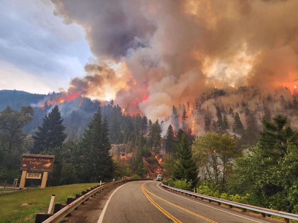 The Smith River Complex wildfires roar above famed Patrick Creek Lodge and U.S. Highway 199.