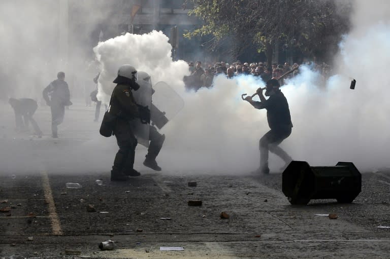 Farmers clash with police in front of the the agriculture ministry in Athens on February 12, 2016 during a protest against pension reforms