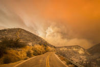 <p>Glowing flames dye the sky orange over the Californian mountains. (Rex)</p>