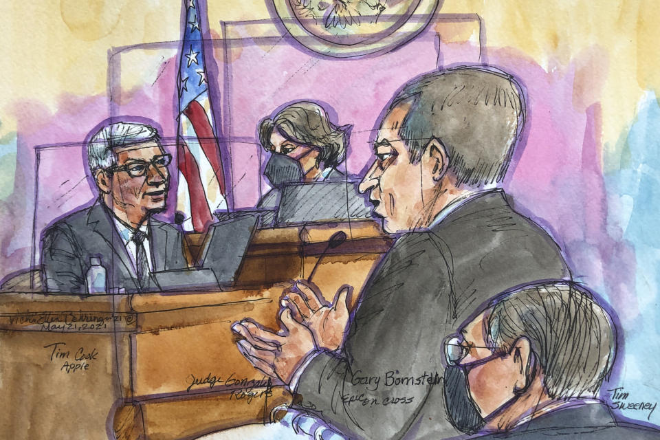 In this courtroom sketch Apple CEO Tim Cook, left, is cross examined by Epic Games lawyer Gary Bornstein, second from right, during a trial in San Ramon, Calif., on Friday, May 21, 2021. Cook described the company's ironclad control over its mobile app store as a way to keep things simple for customers while protecting them against security threats and privacy intrusions during Friday testimony denying allegations he has been running an illegal monopoly. The rare courtroom appearance by one of the world's best-known executives came during the closing phase of a three-week trial revolving around an antitrust case brought by Epic Games, maker of the popular video game Fortnite. (Vicki Behringer via AP)