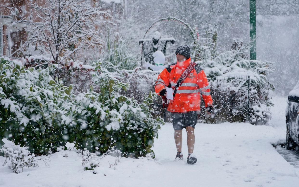 Postmen are made of stern stuff - but now they will need to collect parcels from your door - Owen Humphreys/PA