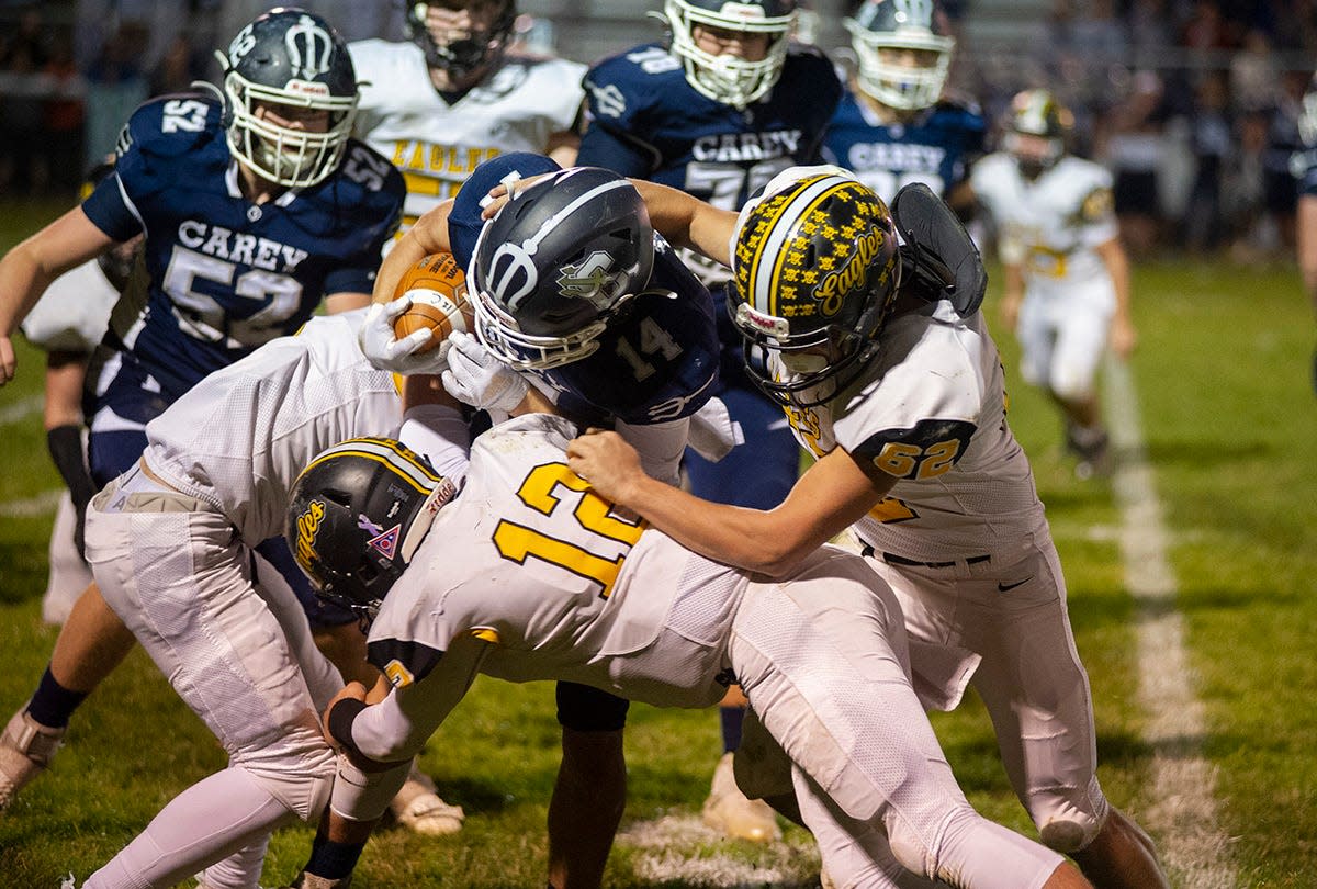 Carey's Conner Norden is brought down by Colonel Crawford's Kam Lohr and Rodney Rike.