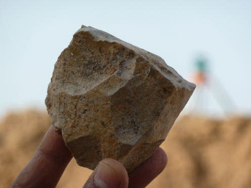 <span class="caption">An Oldowan core freshly excavated at Ain Boucherit from which sharp-edged cutting flakes were removed. </span> <span class="attribution"><span class="source"> M. Sahnouni</span></span>