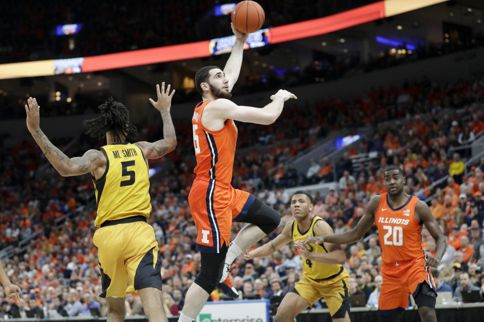 Illinois' Giorgi Bezhanishvili (15) heads to the basket past Missouri's Mitchell Smith (5) during the first half of an NCAA college basketball game Saturday, Dec. 21, 2019, in St. Louis. (AP Photo/Jeff Roberson)