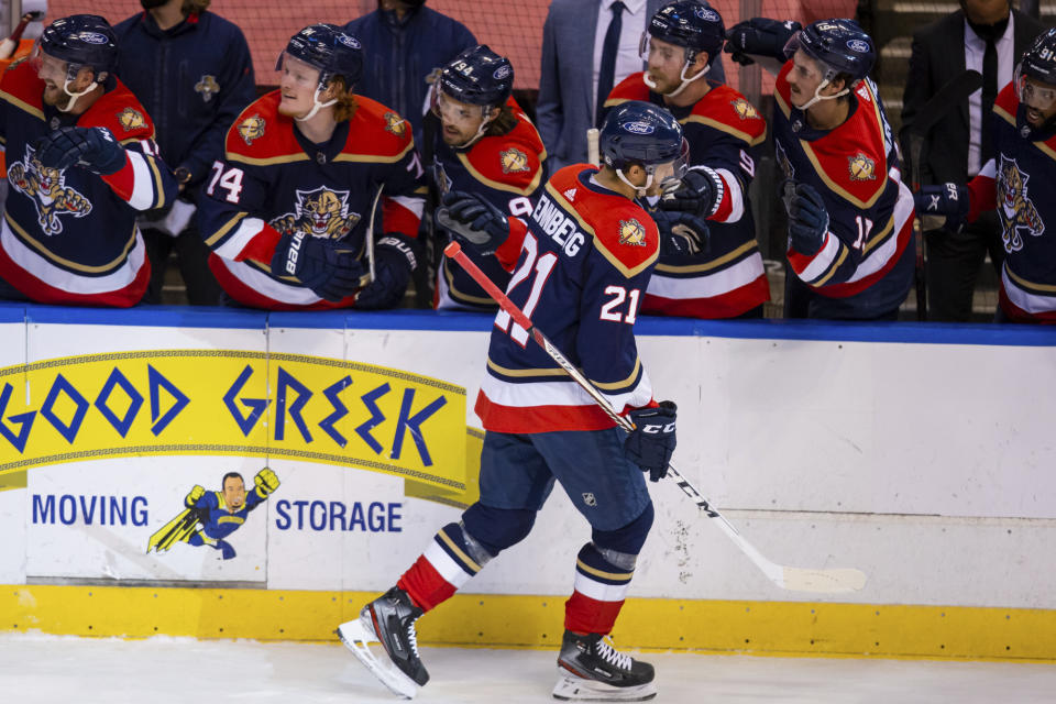 Florida Panthers center Alex Wennberg (21) celebrates with teammates after scoring a goal against the Tampa Bay Lightning during the first period of an NHL hockey game on Saturday, May 8, 2021, in Sunrise, Fla. (AP Photo/Mary Holt)