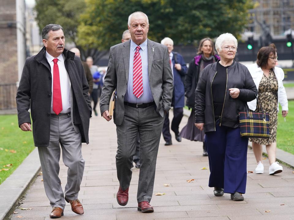 McCord (centre) leads victims of the Troubles and their families through Parliament Square, Westminster, on Tuesday (PA)