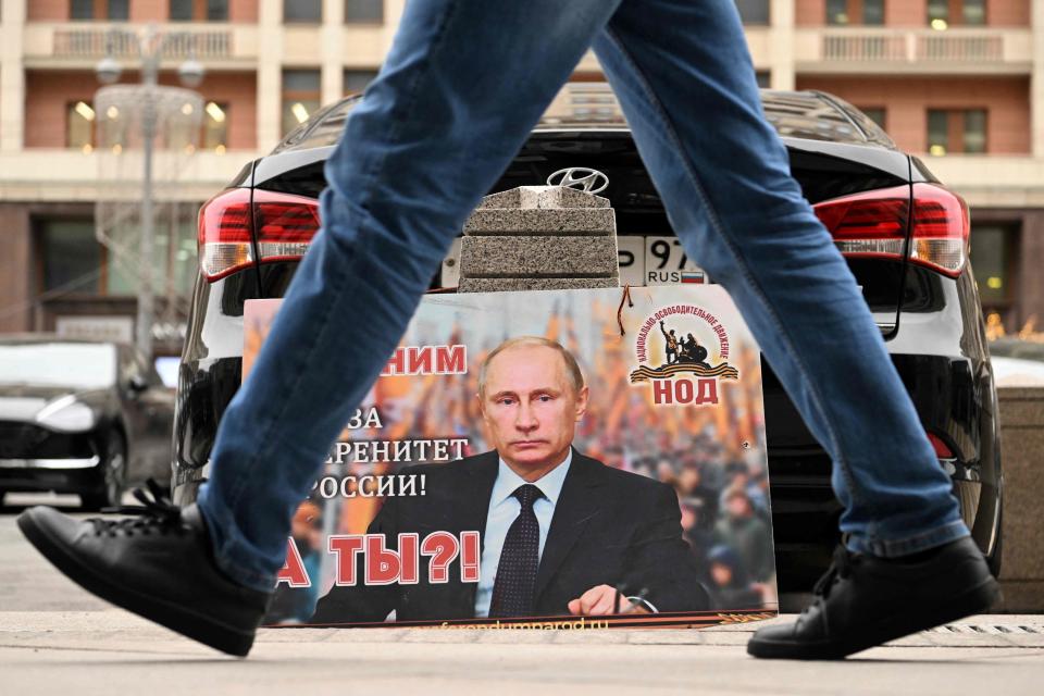 A placard featuring an image of Russian President Vladimir Putin and reading 