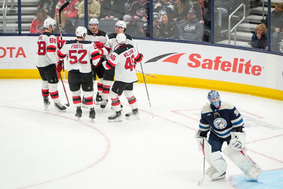 Jan 19, 2024; Columbus, Ohio, USA; Teammates ccelebrate a goal by New Jersey Devils right wing Alexander Holtz (10) behind Columbus Blue Jackets goaltender Elvis Merzlikins (90) during the second period of the NHL hockey game at Nationwide Arena.