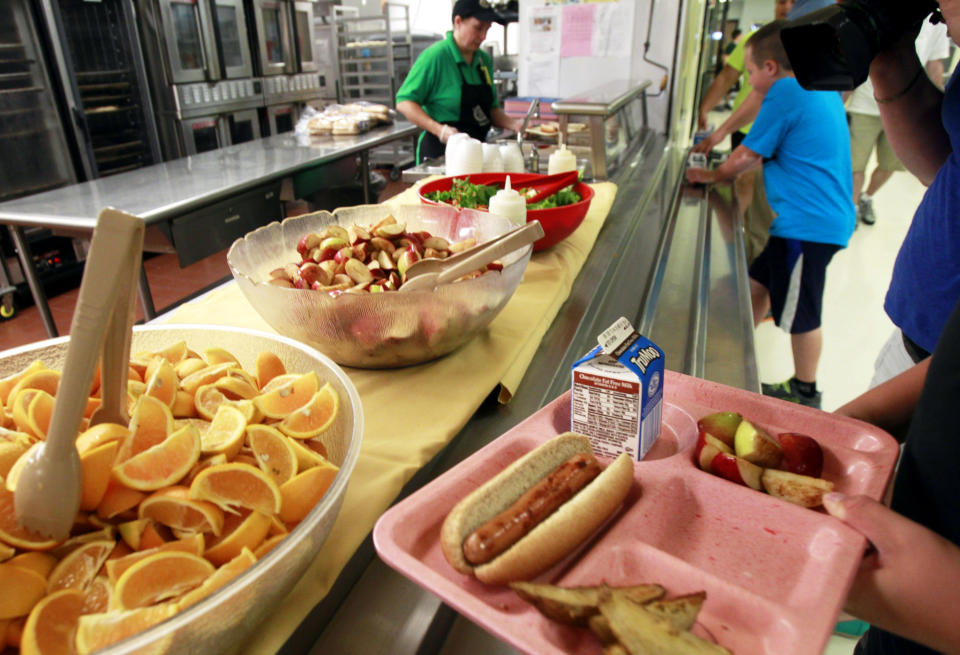 FILE - In this Tuesday, Sept. 3, 2013, file photo, students pick up their lunch at Barre Town Elementary School in Barre Town, Vt. The Agriculture Department said Friday, Jan. 3, 2013, it’s making permanent rules that allow schools to serve larger portions of lean meat and whole grains in school lunches and other meals. (AP Photo/Toby Talbot, File)