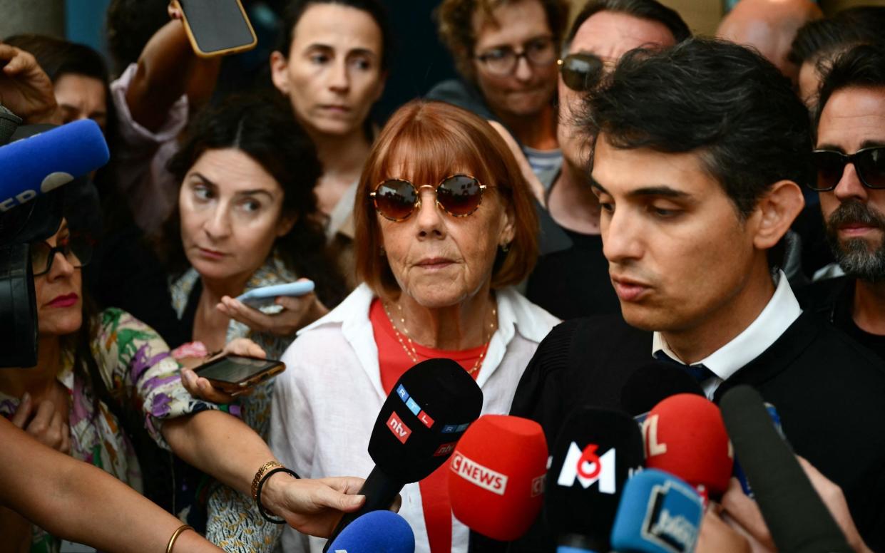 Gisele Pelicot listens to her lawyer Stephane Babonneau (right) addressing reporters as she leaves the courthouse during the trial's fourth day in Avignon, south of France