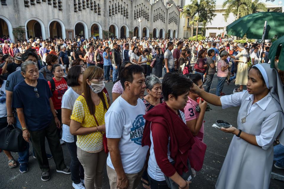 File Photo: A Catholic nun applies ash to a woman's forehead on 'Ash Wednesday' at a church in Manila on March 6, 2019. (Photo: TED ALJIBE/AFP via Getty Images)