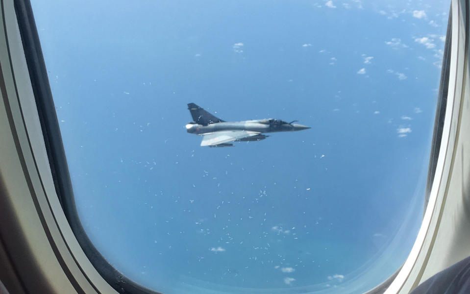 A shot of the French fighter jet through the window of the Jet2 plane - Emily Hatfield/PA Wire