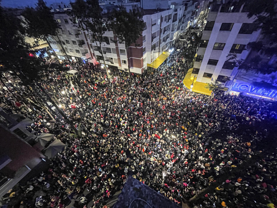 Morocco soccer fans celebrate after their national team beat Canada 2-1 and qualified to the knockout stages at a World Cup soccer match played in Qatar, in Rabat, Morocco, Thursday, Dec. 1, 2022. (AP Photo/Mosa'ab Elshamy)