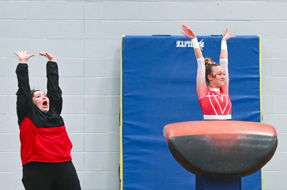 Edgewood head coach Andrea Stroud and Addison Goerges celebrate after Goerges’ vault during the gymnastics meet against Bloomington North and Bloomington South at South on Monday, Jan. 8, 2024.