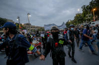 Front line pro-democracy protesters lead a march with linked-arms in Bangkok, Thailand, Sunday, Nov. 8, 2020. The protesters continue to gather Sunday, led by their three main demands of Prime Minister Prayuth Chan-ocha's resignation, changes to a constitution that was drafted under military rule and reforms to the constitutional monarchy. (AP Photo/Sakchai Lalit)