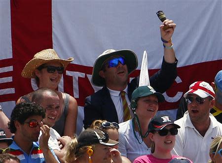 A fan from Barmy Army holds up an Ashes replica urn during the fifth and final day of the third Ashes test cricket match between England and Australia at the WACA ground in Perth December 17, 2013. REUTERS/David Gray