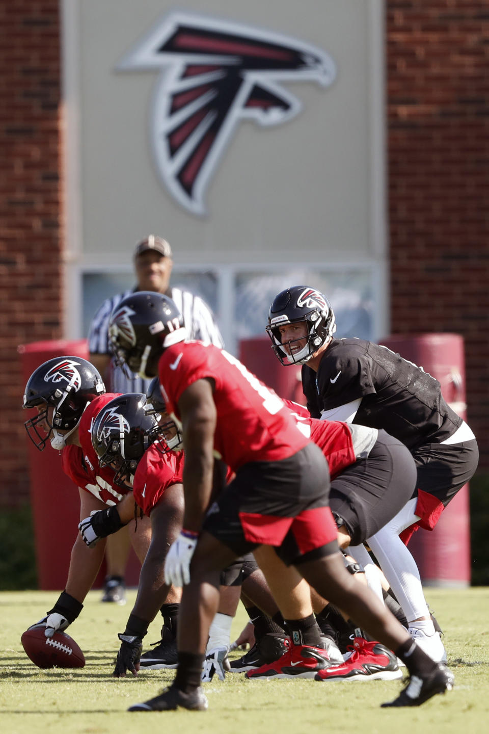 FILE - In this July 25, 2019, file photo, Atlanta Falcons quarterback Matt Ryan (2) and the offense prepare to run a play during their NFL training camp football practice in Flowery Branch, Ga. Several NFL teams are reopening their training facilities Tuesday, May 19, 2020, while many are prohibited by government restrictions during the coronavirus pandemic. Among the teams taking advantage of using their buildings on the first day they are allowed are the Falcons, Cardinals and Colts. (AP Photo/John Bazemore, File)