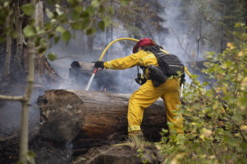 An El Dorado Hills firefighter sprays down hots spots on a containment line during the Caldor fire near Meyers, Calif., in 2021. File Photo by Peter DaSilva/UPI