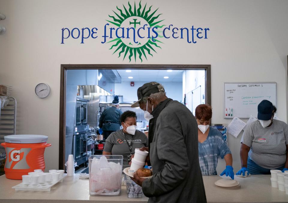 Greg Reed, 59, gathers some breakfast foods from volunteers at the Pope Francis Center in Detroit on Thursday, Sept. 7, 2023. Father Tim McCabe, SJ, president and CEO of the Pope Francis Center is looking forward to expanding its services. The center is currently building a 60,000-square-foot facility called the Pope Francis Center- Bridge Housing Campus, located in the Core City area of Detroit, that will expand services by offering housing, meals, health care including mental health, an athletic facility, computer lab and warming shelter for homeless people during potential extreme weather events.