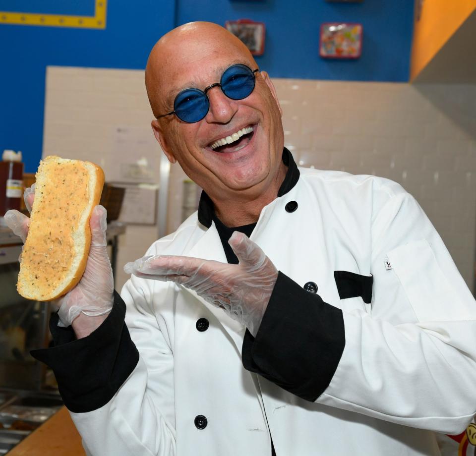 <p>Howie Mandel gets to work in the kitchen of Ike's Love & Sandwiches, where he helped debut a sandwich in his honor, in Woodland Hills, California, on July 18.</p>