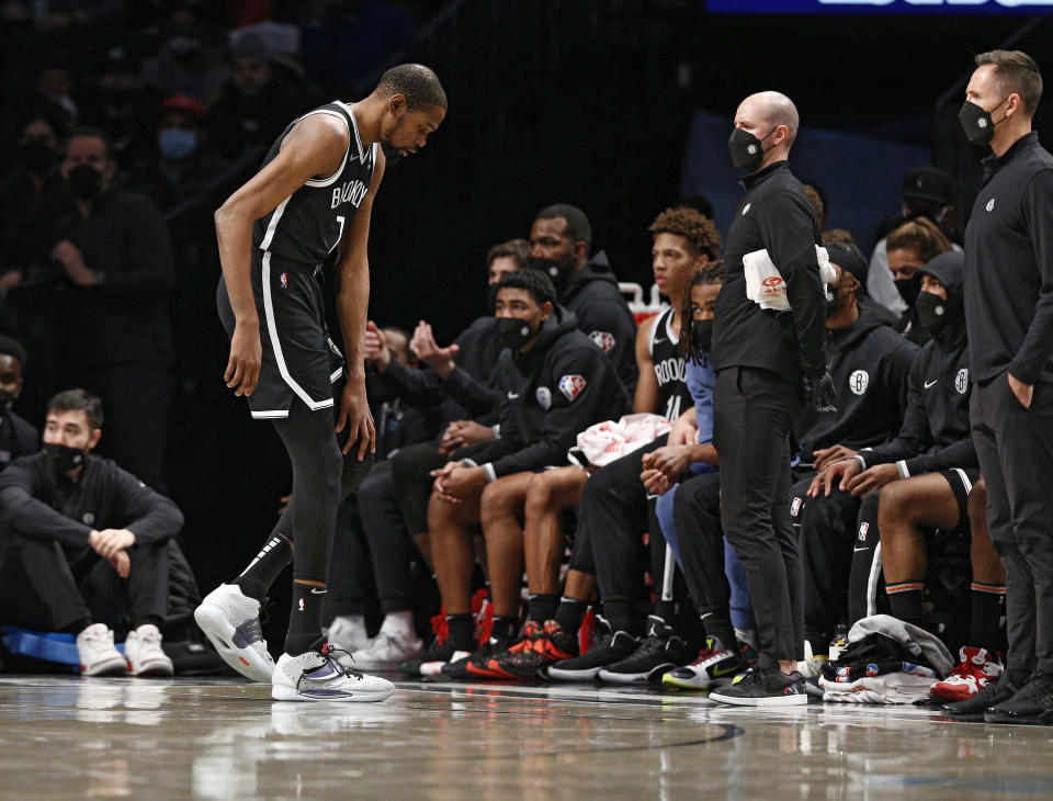 Brooklyn Nets forward Kevin Durant (7) leaves the game after injuring his knee during the first half of an NBA basketball game against the New Orleans Pelicans, Saturday, Jan. 15, 2022 in New York. (AP Photo/Noah K. Murray)