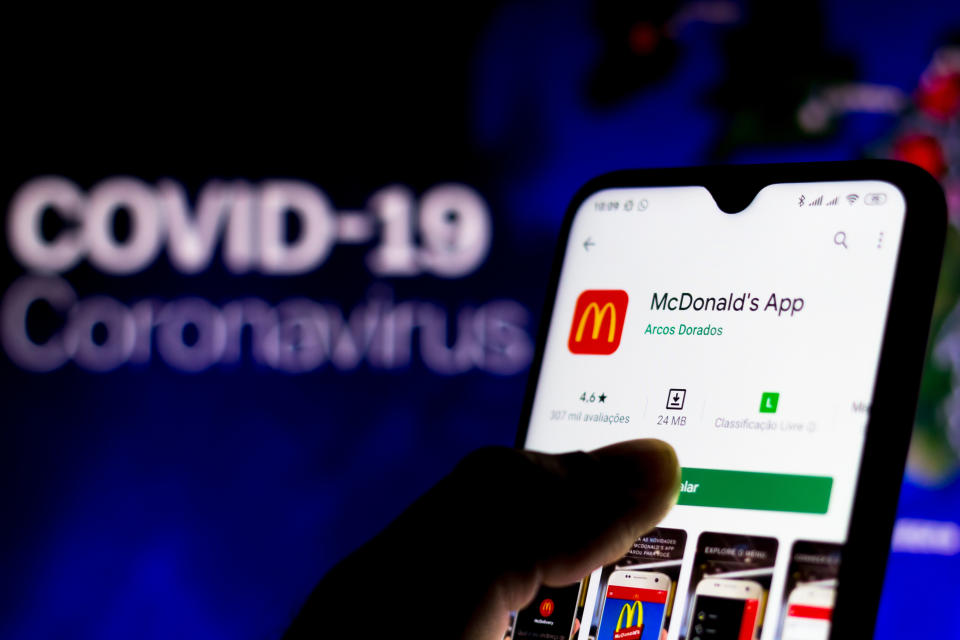 BRAZIL - 2020/04/08: In this photo illustration the McDonalds logo seen displayed on a smartphone with a computer model of the COVID-19 coronavirus in the background. (Photo Illustration by Rafael Henrique/SOPA Images/LightRocket via Getty Images)