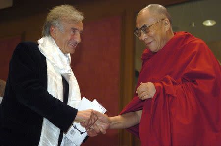 The Dalai Lama (R) greets fellow Nobel Laureate Elie Wiesel (L) after Wiesel's remarks upon receiving the International Campaign for Tibet's Light of Truth Award at a ceremony in Washington, DC, U.S. on November 15, 2005. Wiesel was honored for his practical work in peace. REUTERS/Jonathan Ernst/File Photo