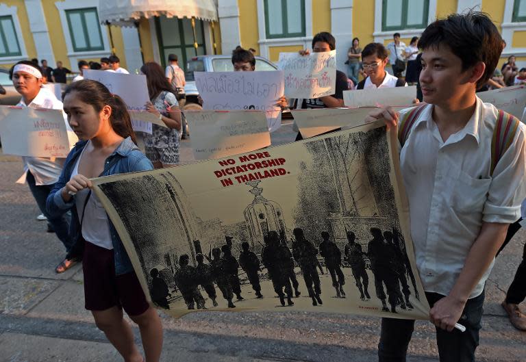 Thai students demonstrate in front of the military court in Bangkok on March 16, 2015 in support of four civilians who appeared at a military court over a peaceful demonstration