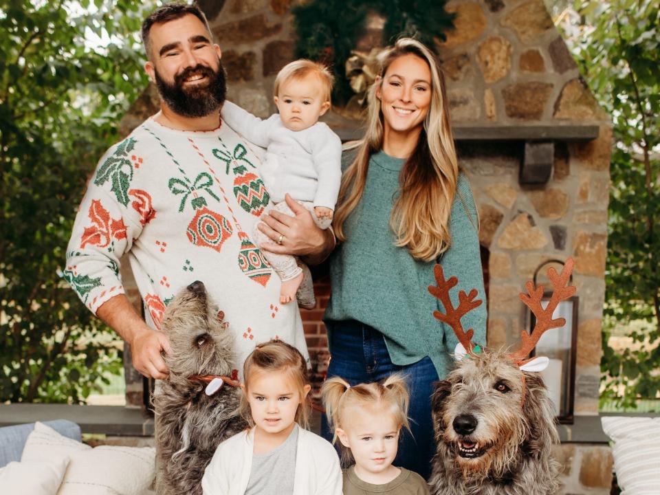 Jason and Kylie Kelce pose for a holiday card with their kids and dogs.