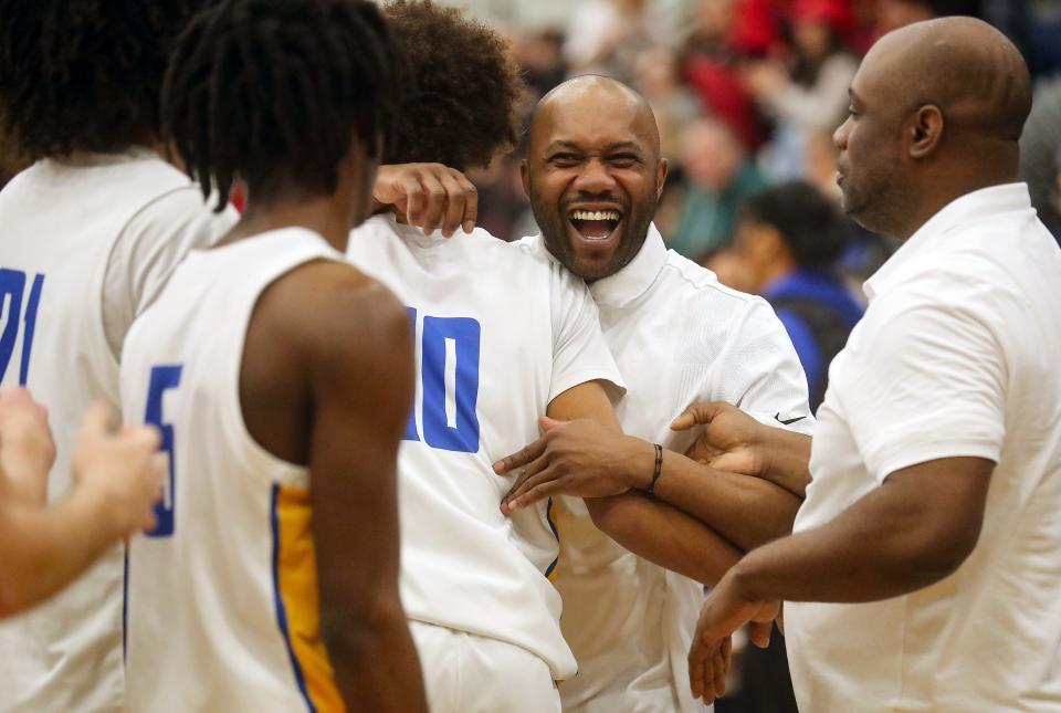 Bremerton head coach Miah Davis celebrates and embraces his son Jalen after their 51-43 win over R.A. Long at Tacoma Community College on Saturday, Feb. 24, 2024.