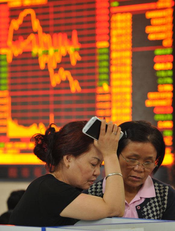 Two stock investors monitor share prices at a securities firm in Fuyang, east China's Anhui province on May 28, 2015