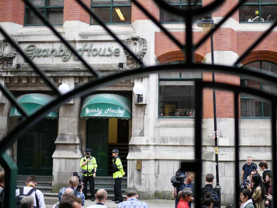 Police guard the entrance to Granby House in the city centre following an armed raid, in Manchester, England (Getty Images)