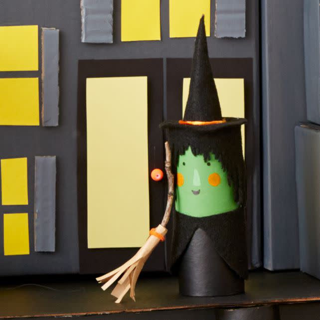 green and black witch with broom mansion of mystery