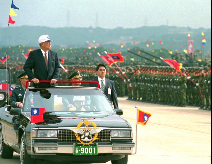 Taiwanese President Lee Teng-hui rides in an an open limousine as he inspects armored divisions during a combined forces mobilization exercise at Lungtan Army Base in northern Taoyuan county in 1997.