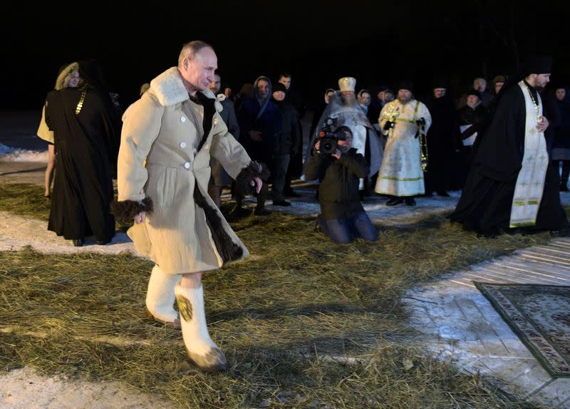 Russian President Vladimir Putin walks to take a dip in the water during Orthodox Epiphany celebrations at lake Seliger, Tver region