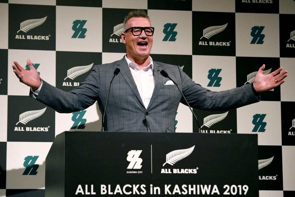 New Zealand's former rugby player John Kirwan smiles and delivers a speech.